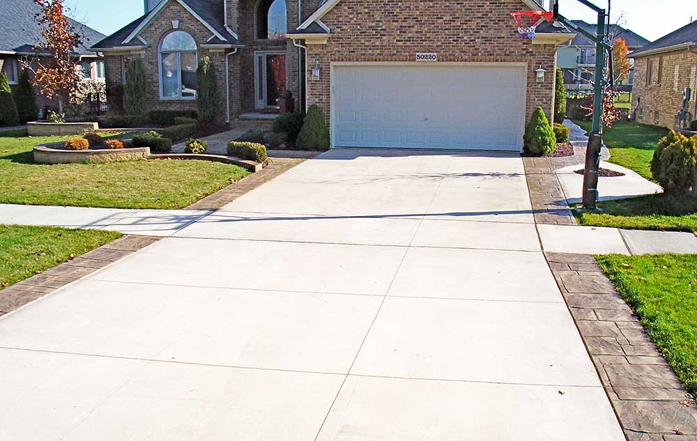 Concrete Driveway Replacement with Stamped Concrete Ribbons in Oakland County, Michigan
